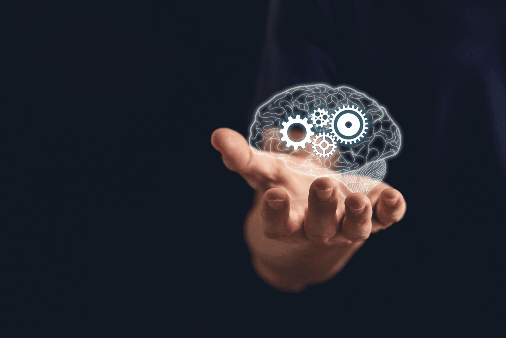 Brain and gears hovering above hand